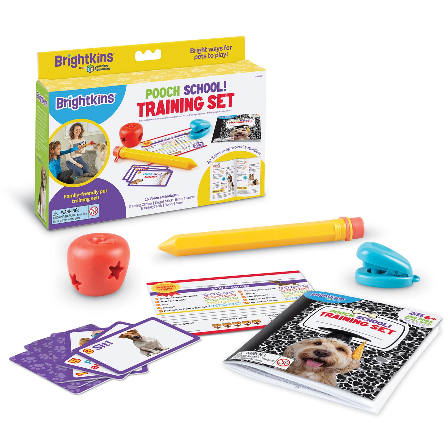A Product box for Pooch School Dog Training Set with contents in front of it: a fake pencil, an apple toy with star shaped cutouts, a training booklet and a set of training cue cards