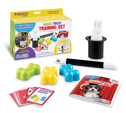 A product box for a Magic Trick Training Set for Dogs, showing the contents: a black top hat with rabbit inside, a magic wand, a set of magic trick cards, a training booklet and 3 colorful bone toys