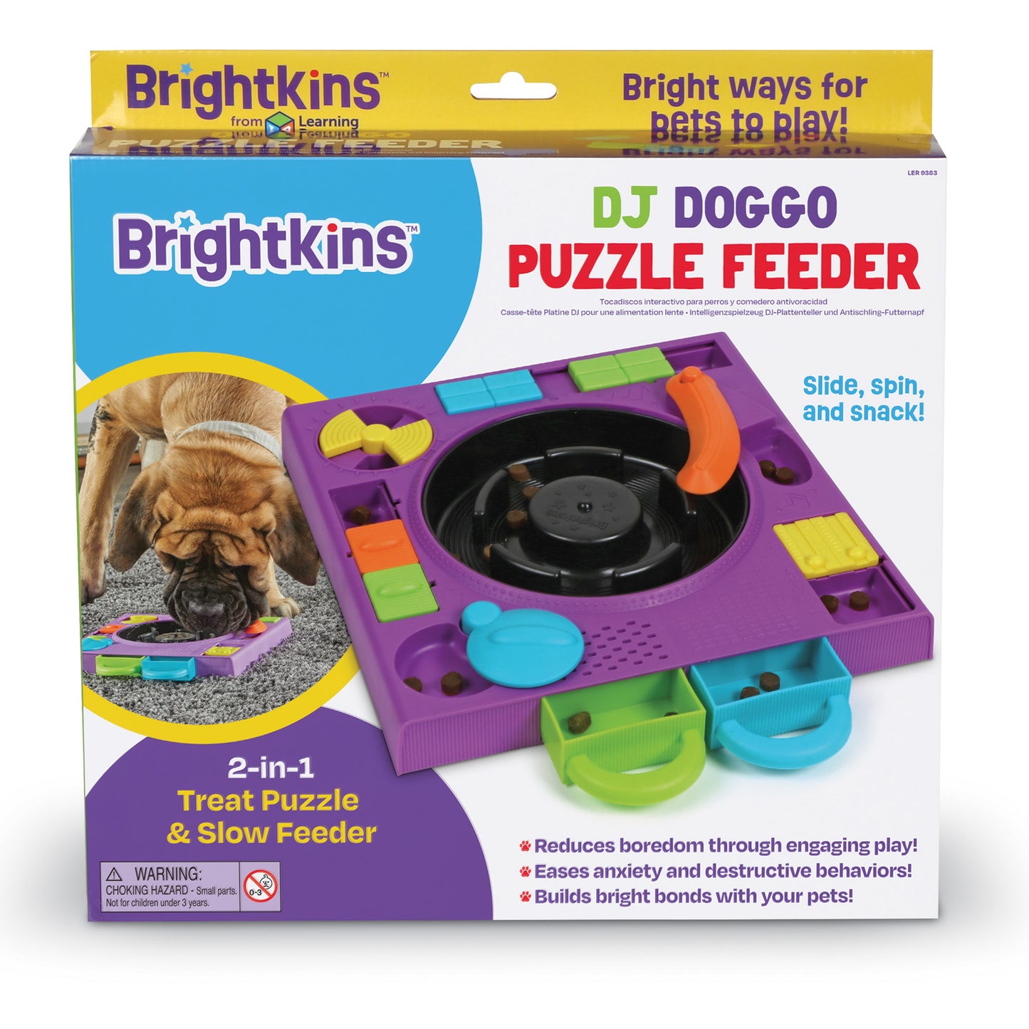 A box containing a purple turntable style food puzzle for dogs