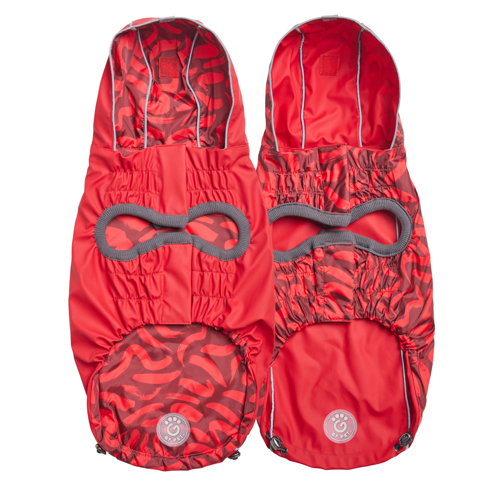 two views of the underside of a reversible raincoat for dogs. One shows the bright red side of the coat and the other shows the bright red and dark red with abstract wavy pattern print side of the coat