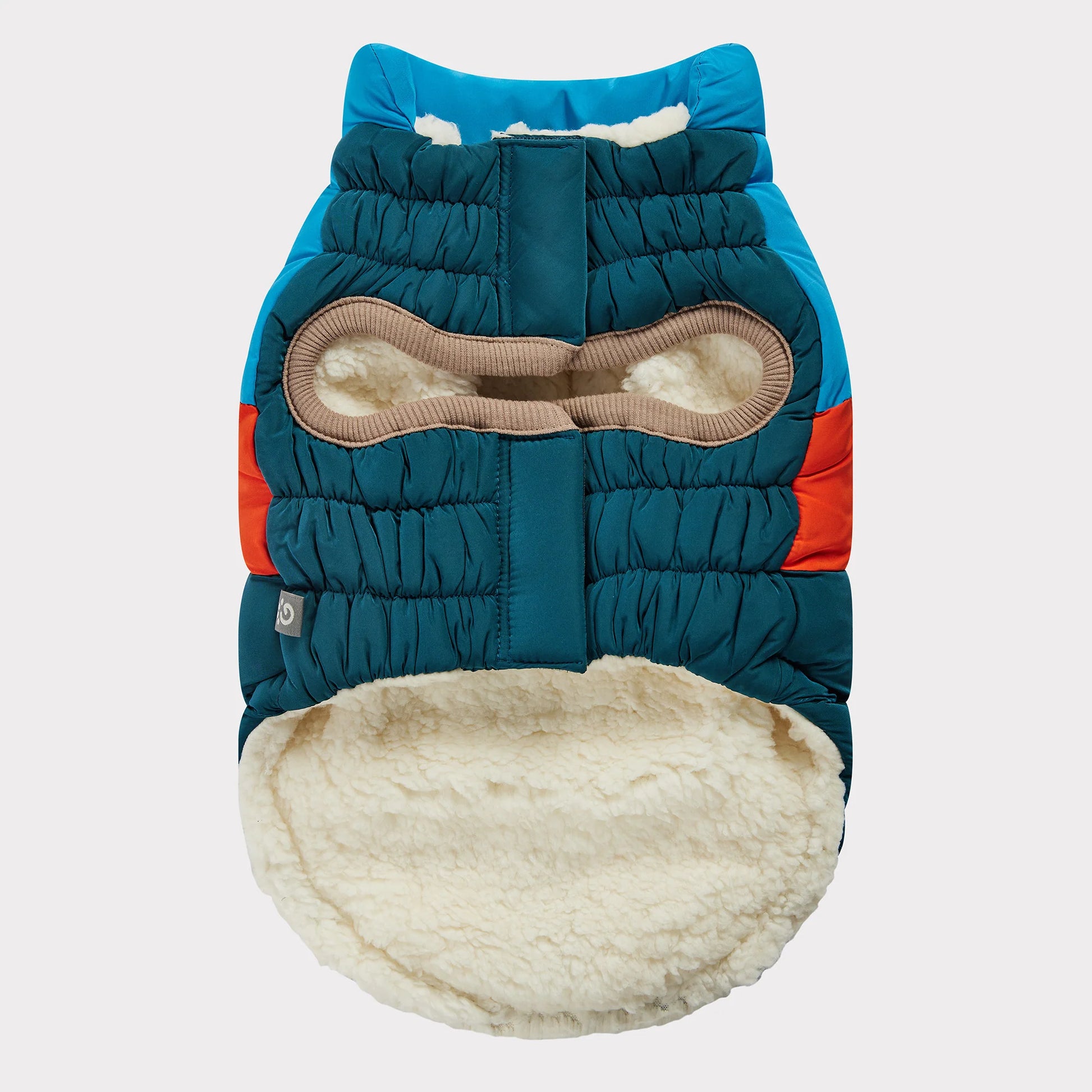 underside view of a blue, orange and teal color blocked puffer jacket for dogs 