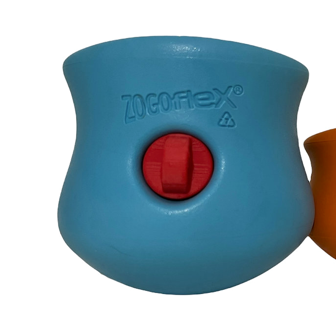 a blue Toppl work-to-eat dog toy with a red Stopple stopper in the front opening 