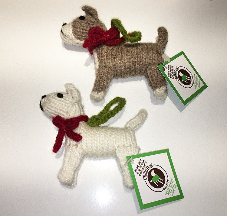 A brown and white dog-shaped knit Christmas ornament and a white dog shaped knit Christmas ornament