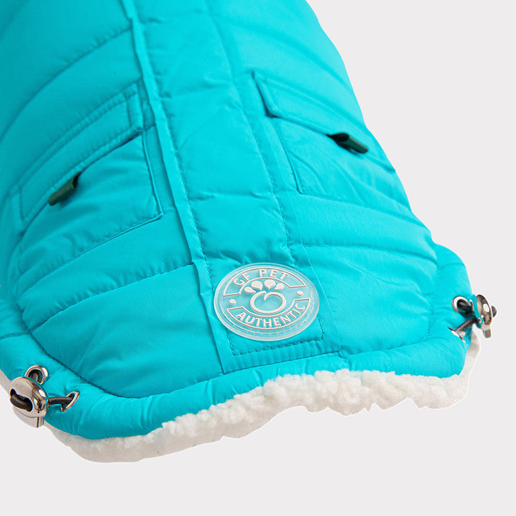close up of the edge of an aqua winter parka for dogs