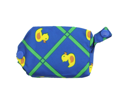A blue rain poncho for dogs with rubber ducky print in a small portable carrying case