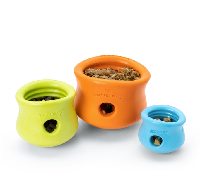 a green, and orange and a blue treat dispensing dog toy