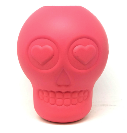 A pink rubber skull shaped dog toy
