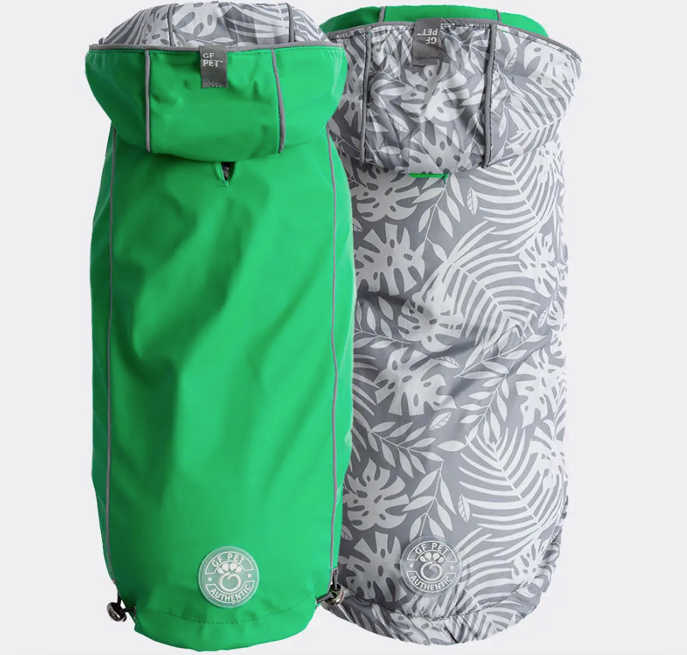 A green dog raincoat that reverses to  grey on grey tropical print 