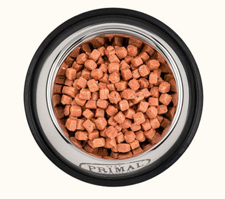 A silver bowl containing frozen raw dogfood toppers
