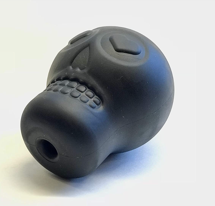 A black rubber skull shaped dog toy