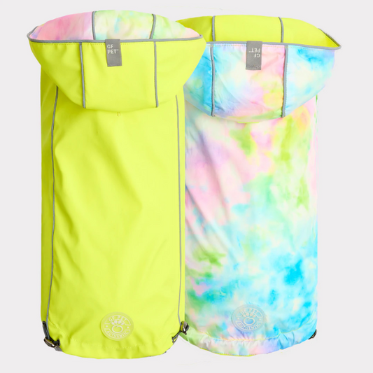 a yellow rain jacket for dogs next to a pink and blue tie dyed rain jacket for dogs, both show different sides of the same product.