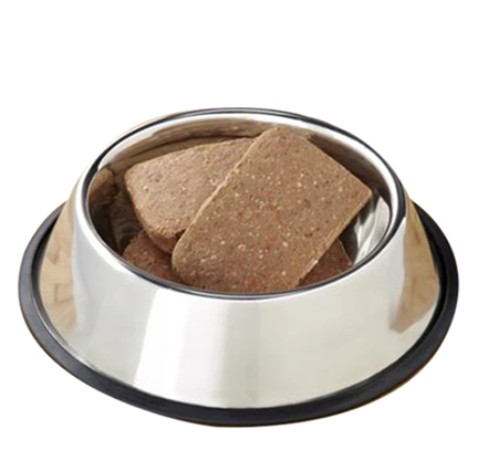 A silver bowl containing three frozen dog food patties