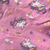 cloe up of pink fabric with unicorn and rainbow print